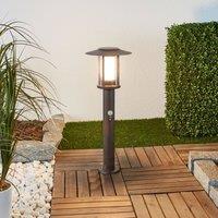 Lindby LED pedestal light Pavlos, 55 cm, rust-coloured, sensor